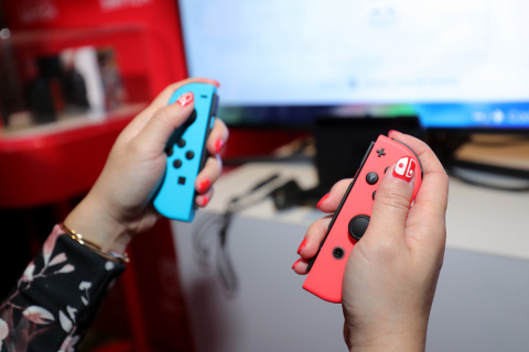 NEW YORK - JAN 13: In this photo provided by Nintendo of America, a guest enjoys playing Mario Kart 8 Deluxe on the groundbreaking new Nintendo Switch video game system at a special preview event in New York on Jan. 13, 2017. Launching March 3, 2017, Nintendo Switch combines the power of a home console with the mobility of a handheld. It's a new era in gaming that delivers entirely new ways to play wherever and whenever people want. (Photo by Neilson Barnard/Getty Images for Nintendo of America)