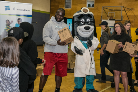 Cindy Spain, RN, Vice President of Health Services, UnitedHealthcare Community Plan; UnitedHealthcare mascot Dr. Health E. Hound; Rees Odhiambo, Seattle Seahawks Guard; and Nancy Giunto, Executive Director, Washington Health Alliance passed out 150 NERF ENERGY Game Kits to members of the Boys & Girls Clubs of King County this morning. The local youth were led through exercises and relays to test out their new NERF ENERGY Game Kit that tracks activity earning “energy points” in order to play the game. The donation is part of a recently launched national initiative and collaboration between Hasbro and UnitedHealthcare, featuring Hasbro’s NERF products that encourages young people to become more active through “exergaming.” L to R: Odhiambo, Dr. Health E. Hound, Spain (Photo: Kim Doyel).
