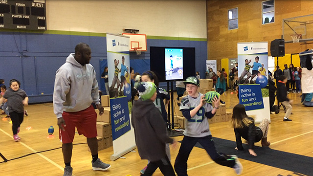 Members of the Boys & Girls Clubs of King County participate in exercises and relays with UnitedHealthcare mascot Dr. Health E. Hound and Rees Odhiambo, Seattle Seahawks Guard, while wearing NERF ENERGY activity bands. Nearly 150 Wallingford Club members received NERF Energy Game Kits from Hasbro and UnitedHealthcare to encourage greater physical activity. The donation is part of a recently launched national initiative and collaboration between Hasbro and UnitedHealthcare, featuring Hasbro’s NERF products that encourages young people to become more active through “exergaming" (Video: Anita Sen).