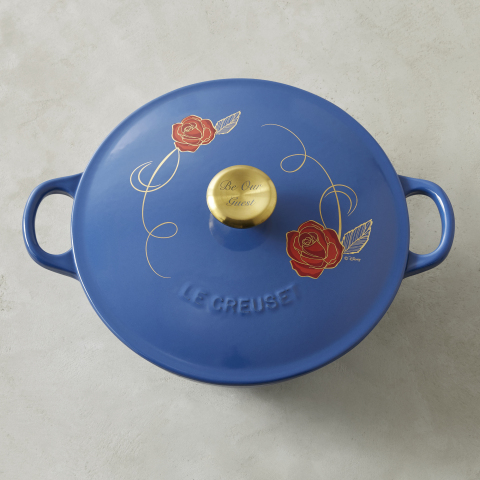 The Beauty and the Beast Soup Pot by Le Creuset is made in France, features a hand-applied red rose-and-vine appliqué design on lid and a stainless-steel knob with gold metallic finish engraved with "Be Our Guest." (Photo: Business Wire)