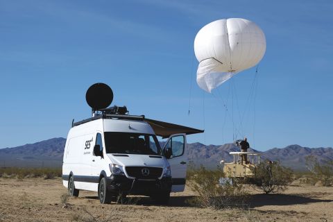 SES's Government+ Rapid Response Vehicle presented at the Humanitarian ICT Forum, and SES's Persistent Surveillance Aerostat (Photo: Business Wire)