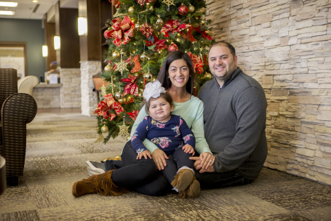 29-year old Tennessee resident Alexa Gash was denied insurance coverage for a life-saving cancer treatment, proton therapy. She is pictured here with her 14-month old daughter Valentina, and her husband Peter, who is an assistant basketball coach at the University of Tennessee-Chattanooga. (Photo: Business Wire)