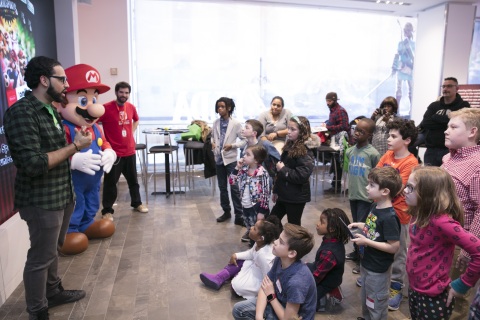 In this photo provided by Nintendo of America, fans gather at the Nintendo NY store in Rockefeller Plaza to celebrate the launch of the Mario Sports Superstars game and compete in an on-site tournament. Fans played five different sports from the game and had the chance to meet Mario. Mario Sports Superstars is an action-packed Nintendo 3DS game that finds players competing in five full-featured sports: Baseball, Soccer, Golf, Tennis and Horse Racing. (Photo: Business Wire)
