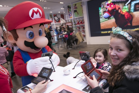 In this photo provided by Nintendo of America, Gia P. from Bronx, NY and Alyssa P. from Bronx, NY meet with Mario at the Nintendo NY store in Rockefeller Plaza on Friday, March 24. Fans gathered to celebrate the launch of Mario Sports Superstars, an action-packed Nintendo 3DS game that finds players competing in five full-featured sports: Baseball, Soccer, Golf, Tennis and Horse Racing. (Photo: Business Wire)