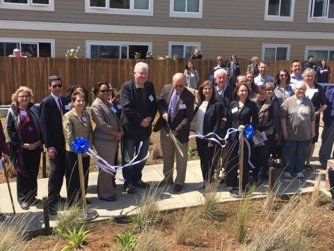 Residents, government officials and business partners cut the ribbon to rededicate Ocean View. (Photo: Business Wire)