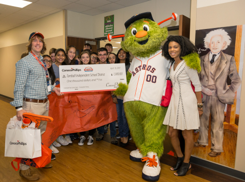 The Houston Astros mascot, Orbit, and ConocoPhillips representative Ty Johnson (right) visit Creekside Park Junior High School in Tomball ISD to congratulate Christopher Penny (left) who was named as a 2017 ConocoPhillips Math Teacher of the Month. (Photo: Business Wire)
