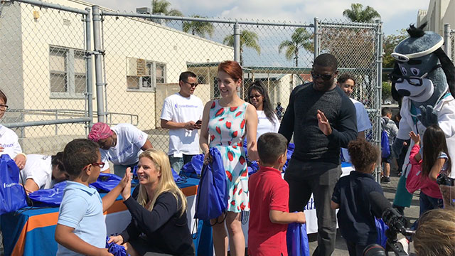 Meghan Newkirk of UnitedHealthcare, actress Megan Hayes and LaDainian Tomlinson of the Los Angeles Chargers distributed 200 backpacks to students today at Horace Mann Elementary School in Long Beach, as part of a collaboration between UnitedHealthcare, LaDainian Tomlinson's Touching Lives Foundation and Blessings in a Backpack (Video: Anita Sen).
