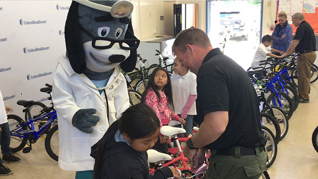 Members of the Sacramento County Sheriff's Department’s Sheriff's Activities League, Sheriff’s Bike Unit, UnitedHealthcare employees and Pro Cycling Team members today delivered 50 bike helmets, 50 bikes and a bike safety lesson to students at Pacific Elementary School in Sacramento, Calif., in advance of the Amgen Tour of California. As part of National Bike Month, the Sacramento Sheriff’s Bike Unit checked each student’s bike and helmet for the appropriate fit, provided general road safety tips and helped students decorate their helmets (Video: Kevin Herglotz).