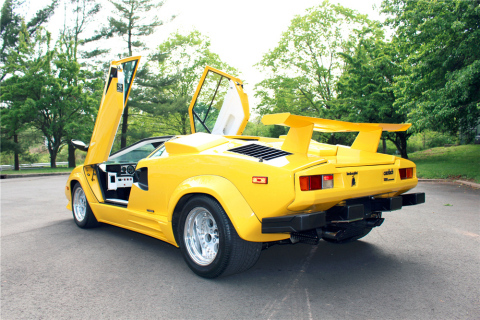 This Fly Yellow ’88 Lamborghini Countach 5000 Quattrovalvole that was built for legendary engineering technician and collector Joe Nastasi, and is signed by Lamborghini legend Valentino Balboni, will cross the Barrett-Jackson Northeast Auction block (Photo: Business Wire)