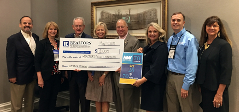 Members of the Northwest Federal Board of Directors and Northwest Federal employees presented the check to representatives from the REALTORS® Relief Foundation (Photo: Business Wire)