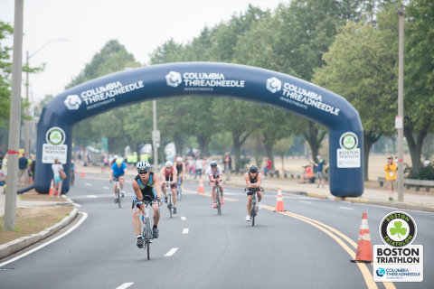 Cyclists ride under the Columbia Threadneedle arch on the streets of South Boston during the 2016 Columbia Threadneedle Investments Boston Triathlon (Photo: Columbia Threadneedle Investments)