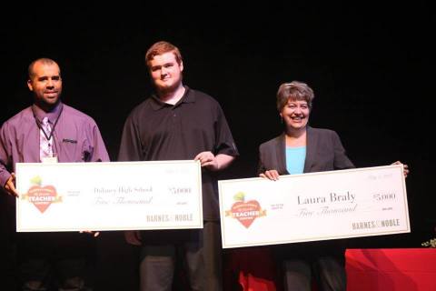 Barnes & Noble Store Manager Jamal Dunn (far left) presents teacher Laura Braly from Dulaney High School in Baltimore, MD with a $5,000 check for winning the title of “Teacher of the Year.” She was nominated by her former student, high school senior Randy Davidson, who accepted an additional check of $5,000 on behalf of the school. (Photo: Business Wire)