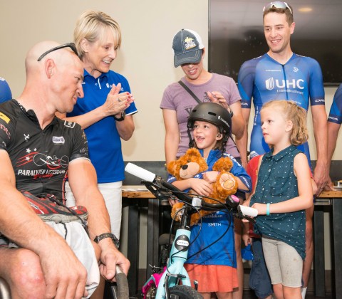 Six-year-old Reagan Cornwall was joined by her sister Ruby and her parents Morgan and Craig when UnitedHealthcare executive Pam Gold and Pro Cycling Team member Adrian Hegyvary surprised her with a brand-new bike, helmet, UHC Pro Cycling team jersey and an opportunity to participate in the cycling event by riding along in the official pace car (Photo: Chad Case Photography).