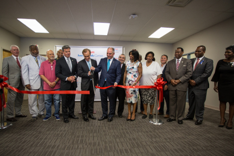 AmeriHealth Caritas Chairman and CEO Paul A. Tufano (center left holding scissors) joined Louisiana Governor John Bel Edwards (center right holding scissors) and other local dignitaries at a ribbon cutting ceremony to open AmeriHealth Caritas Louisiana's Community Wellness Center in Shreveport. 
(Photo: Business Wire)