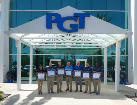 PGT Custom Windows + Doors employees proudly display their Webster University MBA diplomas outside the company's headquarters. (Photo: Business Wire)