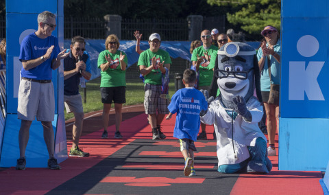 Rick Dunlop, CEO of Medicare & Retirement for UnitedHealthcare of Ohio, and UnitedHealthcare mascot Dr. Health E. Hound congratulated and distributed medals to nearly 120 kids as they crossed the finish line today at the UnitedHealthcare IRONKIDS Ohio Fun Run in Delaware, Ohio. (Credit: Neal Lauron)