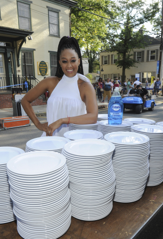 Actress Tia Mowry kicks off the dish washing festivities of over 6,000 dishes with Dawn dish soap to demonstrate how one 21.6 oz bottle of Dawn can clean an entire town’s worth of dishes, Sunday, Aug. 13, 2017 in Lambertville, NJ. (Photo by Diane Bondareff/Invision for Dawn/AP Images)