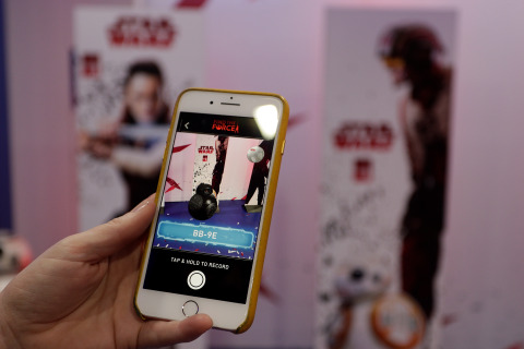 SYDNEY, AUSTRALIA - AUGUST 31: Fans interact with the BB-9E character from Star Wars: The Last Jedi through the Find the Force feature in the Star Wars app. Find the Force is a global augmented reality treasure hunt taking place at 20,000 retail locations around the world over Force Friday II (Sept 1-3) at Westfield Sydney on August 31, 2017 in Sydney, Australia. (Photo by Brook Mitchell/Getty Images for Disney Consumer Products and Interactive Media)