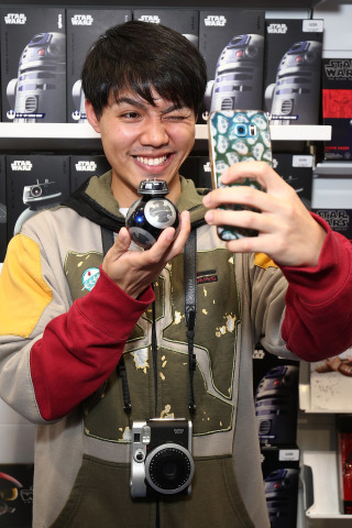 SYDNEY, AUSTRALIA - AUGUST 31: Sydney, Australia – Sept. 1 – Dennis Wong holding the Sphero BB-9E. He was among the very first fans to meet the new Star Wars: The Last Jedi character BB-9E at midnight retail events in Sydney, Australia as Force Friday II gets underway around the world in celebration of the launch of the new product line for Star Wars: The Last Jedi. BB-9E is one of the dark, gleaming BB astromech units of the First Order featured in the upcoming theatrical release, as well as through the range of new products launching globally today. (Photo by Brendon Thorne/Getty Images for Disney Consumer Products and Interactive Media)