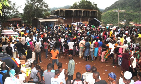 Community members wait in line to receive items. (Photo: Business Wire)