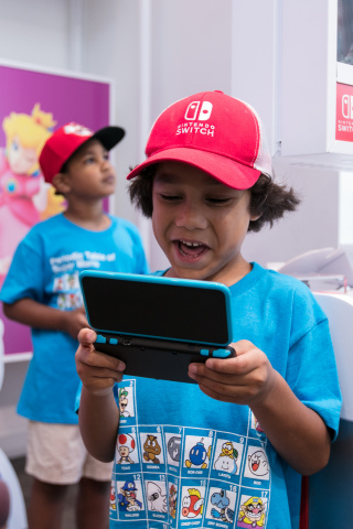 In this photo provided by Nintendo of America, fans gather at the Nintendo NY store for the Nintendo Back-to-School Celebration. Fans played games, received Nintendo school supplies, signed a pledge to work hard this school year and had the chance to have their photo taken with Mario. (Photo: Business Wire)
