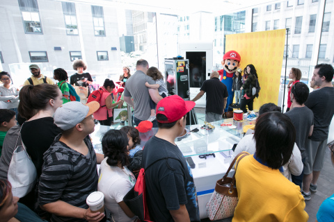 In this photo provided by Nintendo of America, fans gather at the Nintendo NY store for the Nintendo Back-to-School Celebration. Fans played games, received Nintendo school supplies, signed a pledge to work hard this school year and had the chance to have their photo taken with Mario.