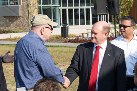 Delaware Senator Chris Coons shakes the hand of retired CSC employee John Pelletier, who managed the NYC office on September 11 and evacuated employees before the South Tower was hit ensuring the safety of everyone in the office that day. (Photo: Business Wire)