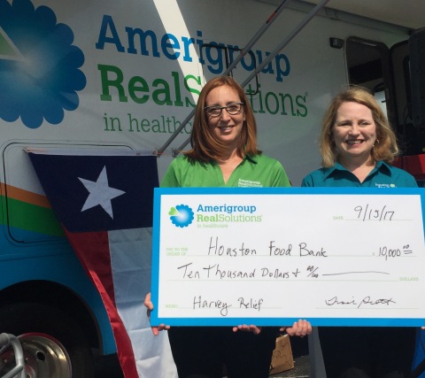 Amerigroup Texas President Tisch Scott presenting a $10,000 contribution to Houston Food Bank Chief Development Office Amy Ragan at the launch of Amerigroup Mobile Health Clinic Road Tour, which will bring health services and supports to Houston residents impacted by Hurricane Harvey. (Photo: Business Wire)