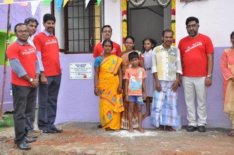Wells Fargo team turns over keys to one of the flood affected families in a dedication ceremony orga ... 