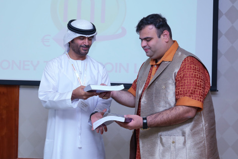 Amit Lakhanpal presents the book 'The World of Cryptocurrency' to H.E. Sheikh Saqer Al Nahyan (Photo: AETOS Wire)