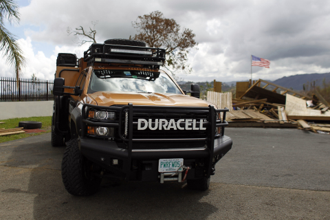 A Duracell PowerForward vehicle is seen parked in front of a destroyed house with a U.S. flag, Friday, Oct. 13, 2017 in Naranjito, Puerto Rico. (Ricardo Arduengo/AP Images for Duracell)