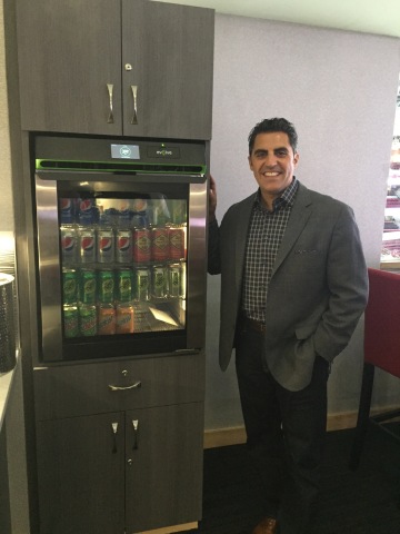 Phononic CEO Tony Atti unveils the food and beverage refrigerator installed in PNC Arena’s loge boxes. (Photo: Business Wire)