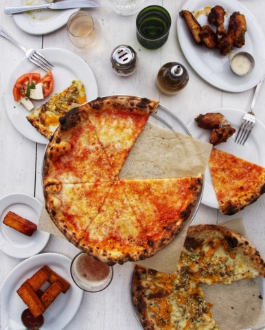 Genuine Pizza will offer chef-curated, quick-fired pizza and a menu to build a meal around it including snacks, soups, salads and entrées crafted with honest ingredients (Photo: Business Wire)
