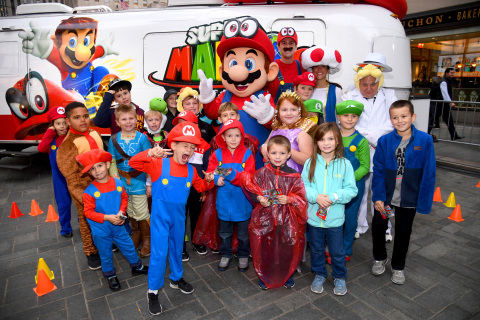 Fans pose for a photo with Mario as they await the launch of his newest game, Super Mario Odyssey on October 26, 2017 at Rockefeller Plaza in New York City. (Photo by Dave Kotinsky/Getty Images for Nintendo of America)