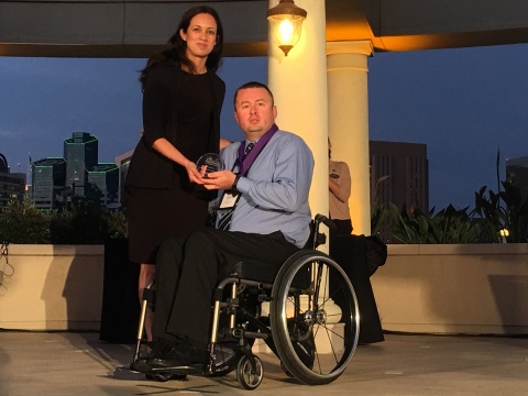 WorkCompCentral's Kristen Chavez presents Jeremy Romero with 2017 Comp Laude Award. (Photo: Business Wire)