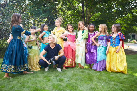 Photographer Kate T. Parker poses with girls from youth soccer team, The Blasters, during a shoot for the "Dream Big, Princess" photo campaign. (Photo: Business Wire)