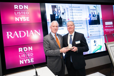 Radian CEO Rick Thornberry is presented with a medal by NYSE Client Services Manager Jim Byrne to celebrate 25 years of trading. (Photo: Business Wire)