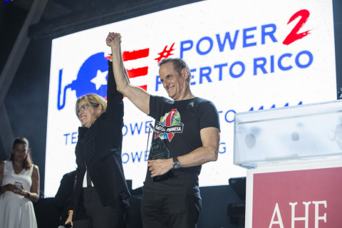 AIDS Healthcare Foundation President Michael Weinstein (right) salutes the heroic leadership of San Juan, Puerto Rico Mayor Carmen Yulin Cruz (left) at AIDS Healthcare Foundations (AHF) 30th Anniversary Celebration and World AIDS Day concert that featured Becky G., Yandel and Sheila E., at The Bayfront Park Amphitheater on Friday, Dec. 1, 2017, in Miami, that also raised funds to continue to support relief efforts in Puerto Rico. (Photo by Jesus Aranguren/Invision for AIDS Healthcare Foundation/AP Images)