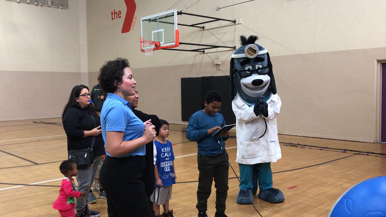 UnitedHealthcare donated 200 NERF Energy Game Kits to the YMCA of Superior California as part of a national initiative to encourage young people to become more active through "exergaming." UnitedHealthcare’s Nicole Borreli (light blue shirt) and mascot Dr. Health E. Hound cheer for Syeed Williams, 9, of Sacramento as he plays the NERF ENERGY Rush game. The donation is part of a recently launched national initiative between Hasbro and UnitedHealthcare, featuring Hasbro’s NERF products, that encourages young people to become more active through “exergaming” (Video: Anita Sen).