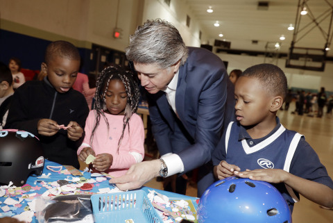UnitedHealthcare of Nevada CEO Don Giancursio helps Elton Sunnyway, left, Breyonna Hooker and D.J. Owen decorate bike helmets, some of the 150 donated along with a $25,000 check to Boys & Girls Clubs of Southern Nevada following a CES 2018 fundraiser on Monday, Jan. 15, 2018, in Las Vegas (Photo by Isaac Brekken for UnitedHealthcare).