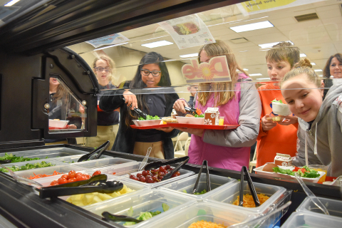 Students at Saint Ambrose Catholic School line-up to use a new salad bar, donated by Dole Food Company and Marc's Stores to encourage healthier food options. (Photo: Business Wire)