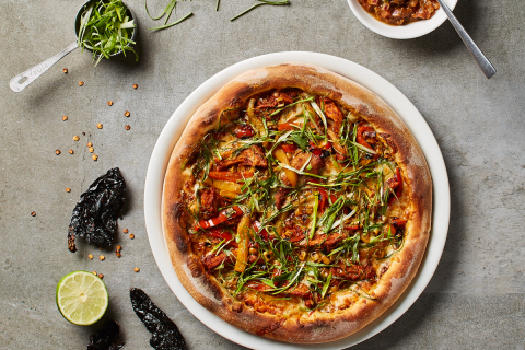 Created by California Pizza Kitchen's 2017 "Pizza Chef of the Year," CPK's new Citrus Adobo Pizza features slow-cooked pork carnitas tossed in housemade ancho chili adobo sauce, with sweet white corn, roasted peppers, quesadilla and Monterey Jack cheeses, fresh cilantro and lime, served with a side of spicy chili de arbol salsa. (Photo: California Pizza Kitchen and Waterbury Publications)