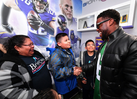 Minnesota boy battling leukemia gets a surprise visit from comedian Kevin Hart at the unveiling of his football-themed “Imagine Me” bedroom makeover from nonprofit BrittiCares and digital health company Rally Health on Feb 3. Here, Kevin Hart greets Andrew and the Rojas family. Photo credit: Getty Images.