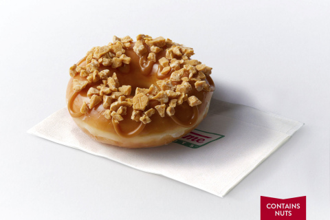 The Hershey’s Gold Doughnut is a delicious pairing of Krispy Kreme’s iconic Original Glazed Doughnut, topped with pieces of the new Hershey’s Gold bar and a salted caramel icing. This product does contain nuts. (Photo: Business Wire)