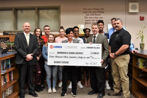 84 Lumber and Nemacolin Woodlands Resort President and Owner Maggie Hardy Magerko (center) presents to Brownsville School District so they can purchase and install new metal detectors. (Photo: Business Wire)