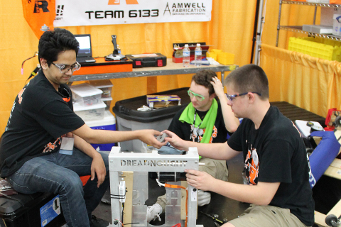 Members of the Haltom Robotics team from Haltom City, Texas, fine tune their robot at the 2017 FIRST Championship. (Photo: Business Wire)
