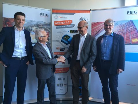 Good cooperation: A handshake between Eldor Walk, managing director of FEIG ELECTRONIC GmbH (2nd from right) and Peter Schmidt, founder of PANMOBIL, confirms the acquisition of the AutoID specialist by FEIG. Andreas Binder, head of PANMOBIL product line, from PANMOBIL (left) and Markus Desch, technical director, from FEIG (right) are responsible for the successful integration into the FEIG Group. (Photo: Business Wire)
