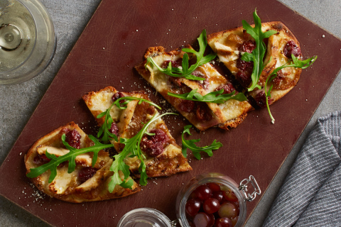 California Pizza Kitchen's new Sonoma Grilled Chicken Flatbread features marinated red grapes roasted in the hearth oven with grilled chicken, double cream Brie and Parmesan cheeses, caramelized onions, and fresh arugula. (Photo: Business Wire)