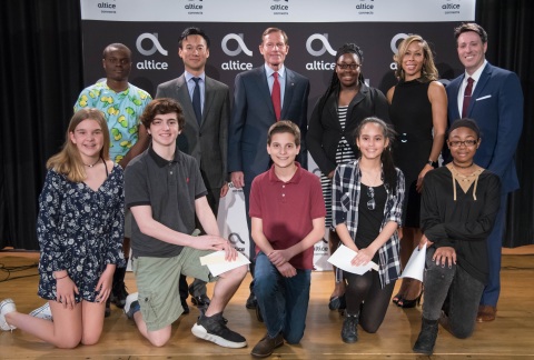 Dolan Middle School students with (top row, L-R) (pictured 2nd) Altice USA Chairman and CEO Dexter Goei, (pictured third) U.S. Senator Richard Blumenthal, (pictured fifth) Principal Charmaine Tourse and (pictured sixth) Moderator Eric Landskroner (Photo: Business Wire)