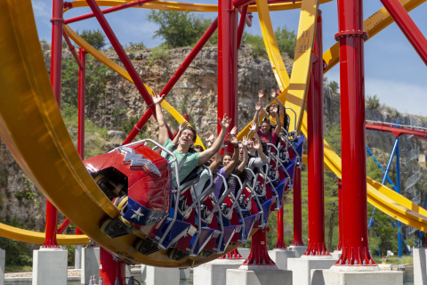 The world's first-of-its-kind single rail coaster, WONDER WOMAN: Golden Lasso Coaster debuts at Six Flags Fiesta Texas in San Antonio. This cutting-edge marvel features a single I-beam rail with riders seated single file on either side of the thin monorail track. This pioneering new design gives riders an open-air, unobstructed view as they twist and turn above the stunning quarry walls. (Photo: Business Wire)